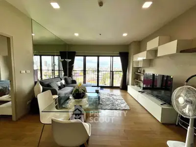Modern living room with city view, stylish furniture, and elegant decor