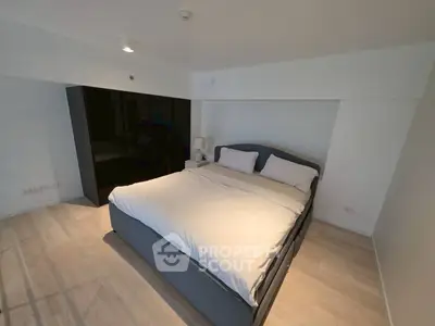 Spacious modern bedroom with sleek design and ample natural light