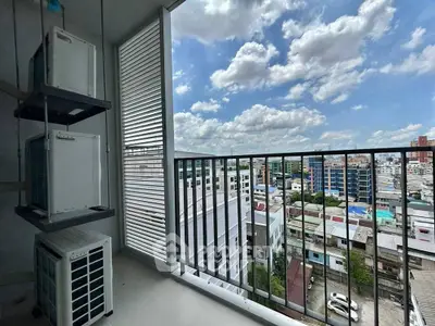 Stunning balcony view overlooking cityscape with blue skies and clouds, perfect for urban living.