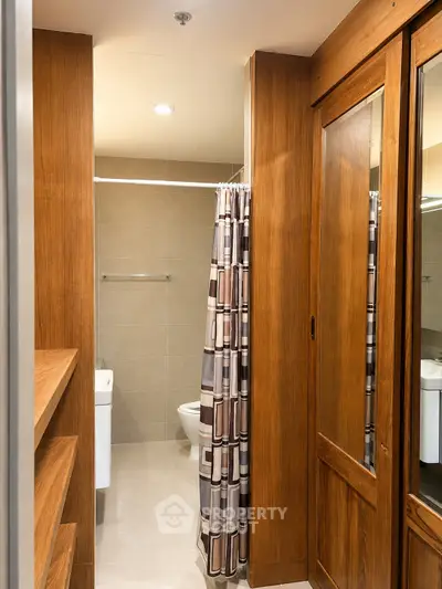 Elegant bathroom with wooden accents and modern shower curtain