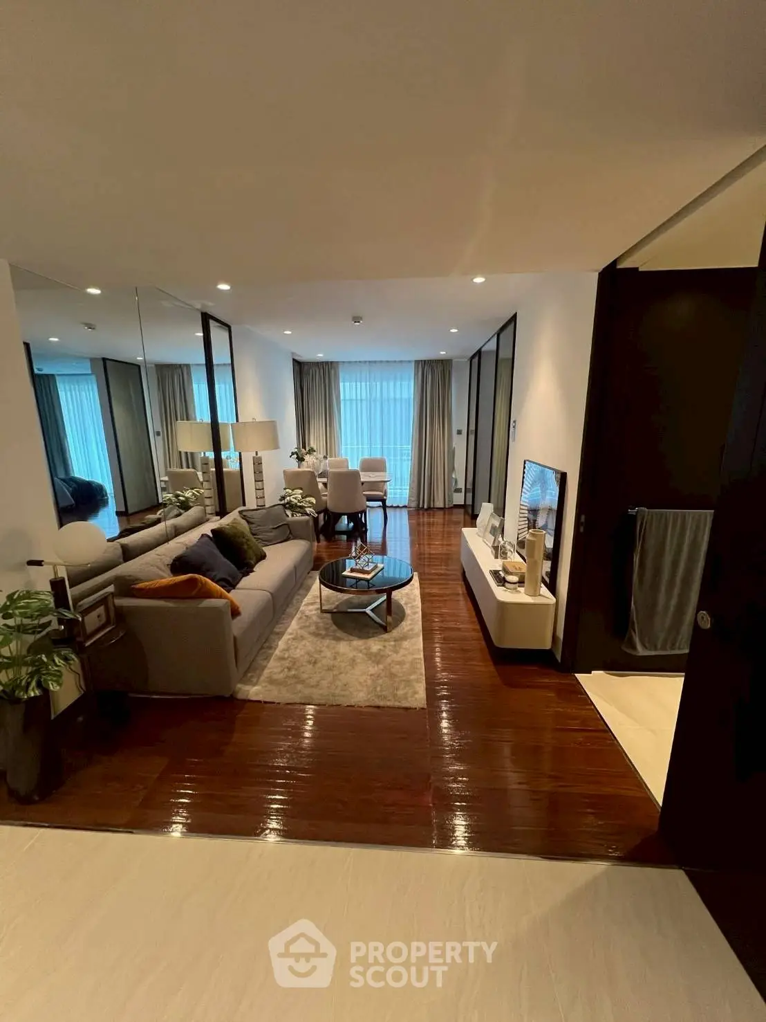 Luxurious living room with elegant decor and large windows offering natural light.