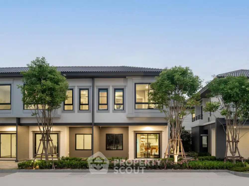 Modern two-story house with landscaped garden and large windows