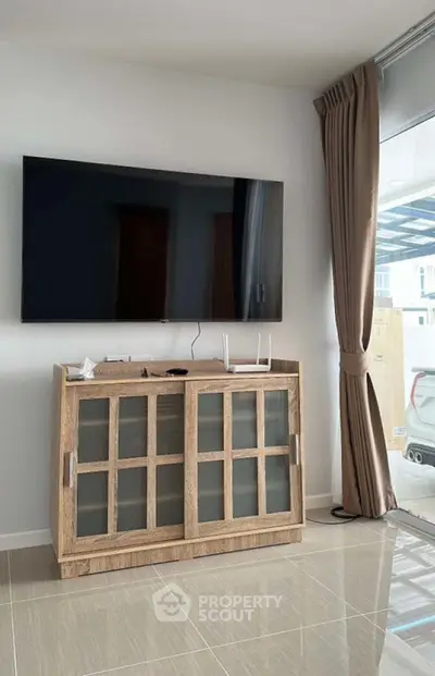 Modern living room with sleek TV setup and stylish wooden cabinet