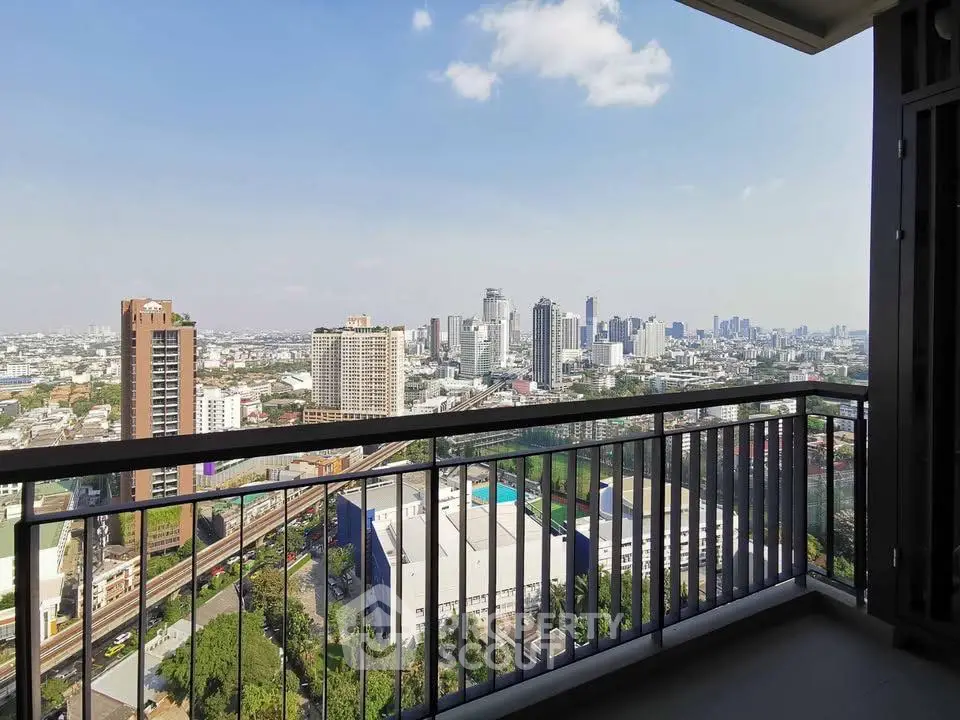 Stunning cityscape view from a modern balcony in a high-rise apartment.