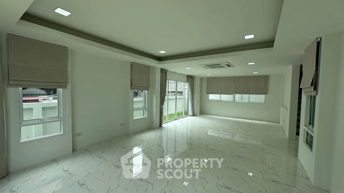 Spacious modern living room with marble flooring and large windows