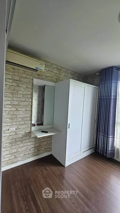 Spacious bedroom with modern wardrobe and natural light