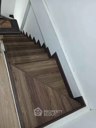 Elegant wooden staircase with modern design in a contemporary home interior.