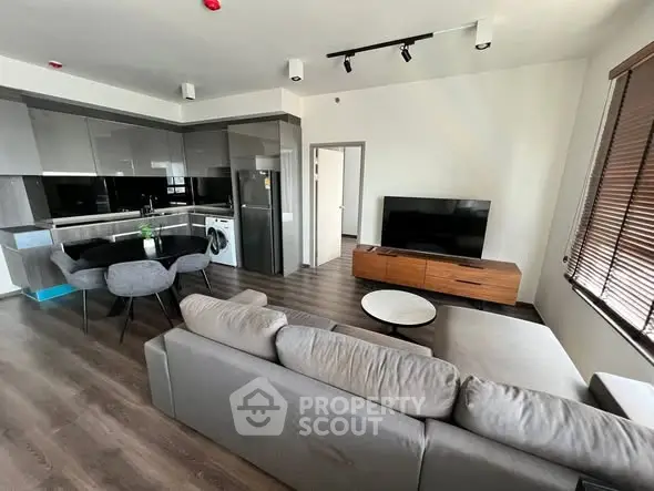 Modern open-plan living room with sleek kitchen and stylish furnishings