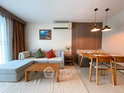 Modern living room with cozy sofa, dining area, and stylish decor in a bright apartment.