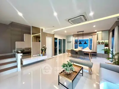 Spacious modern living room with sleek design and elegant decor, featuring open layout and stylish lighting.