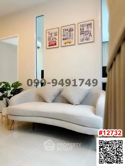 Stylish living room with modern sofa and decorative wall art in a cozy apartment.