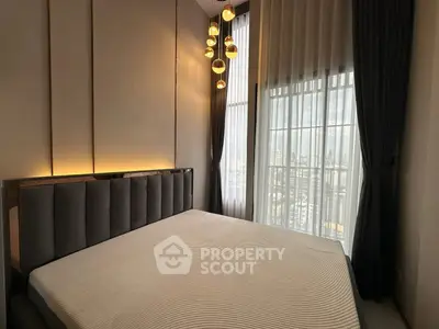 Luxurious bedroom with modern lighting and large window view