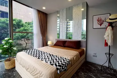 Modern bedroom with large window and stylish decor in urban apartment
