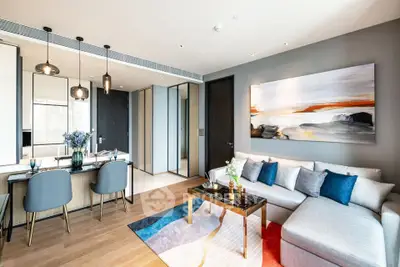 Modern living room with stylish decor and open dining area in a luxury apartment.