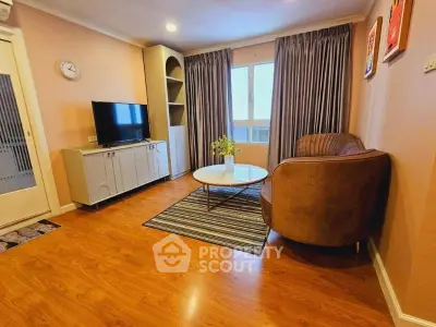 Cozy living room with modern decor, wooden flooring, and natural light.
