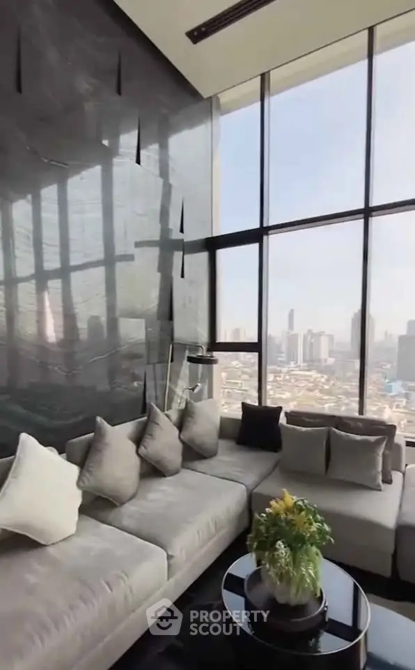 Luxurious living room with floor-to-ceiling windows and stunning city view