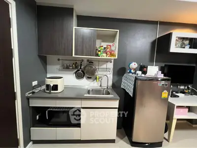 Modern compact kitchen with sleek cabinets and stainless steel appliances