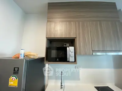 Modern kitchen with sleek cabinetry and built-in microwave