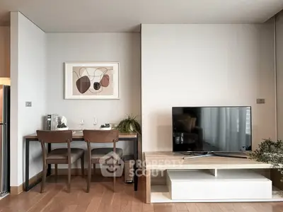Modern living room with stylish decor, TV unit, and dining area in a cozy apartment.