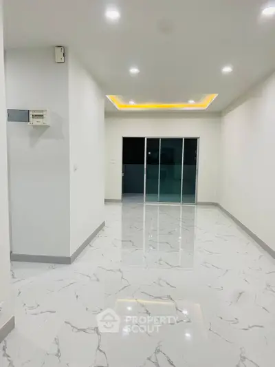 Spacious modern interior with glossy marble flooring and recessed lighting