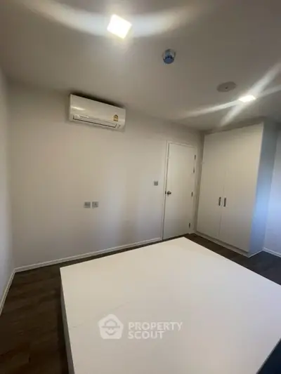 Modern bedroom with air conditioning and built-in wardrobe