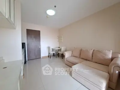 Cozy living room with beige sofa and dining area in modern apartment