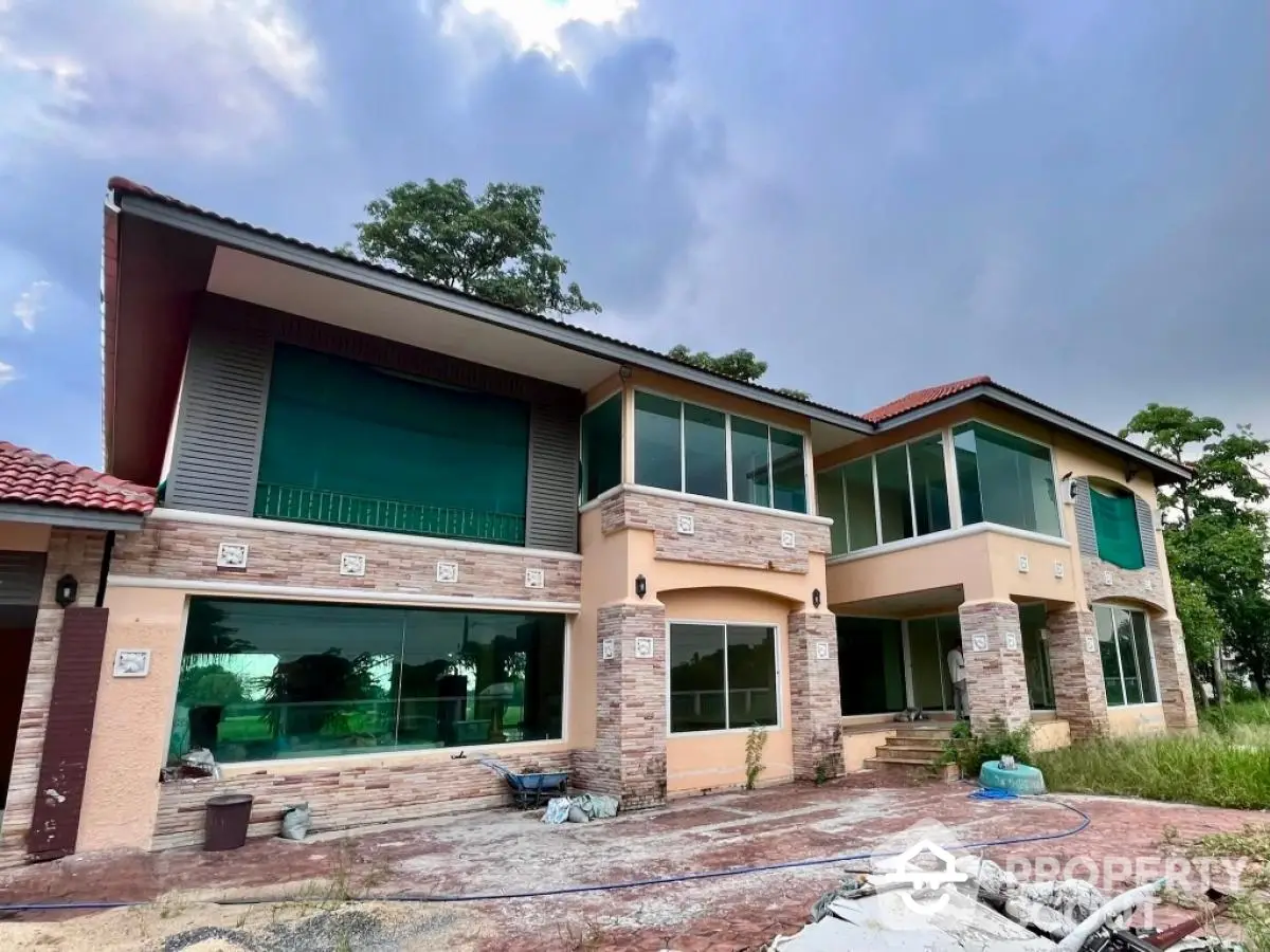 Stunning two-story house with modern design and large windows in a serene neighborhood.