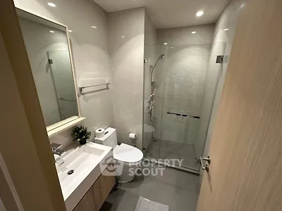 Modern bathroom with glass shower and sleek fixtures