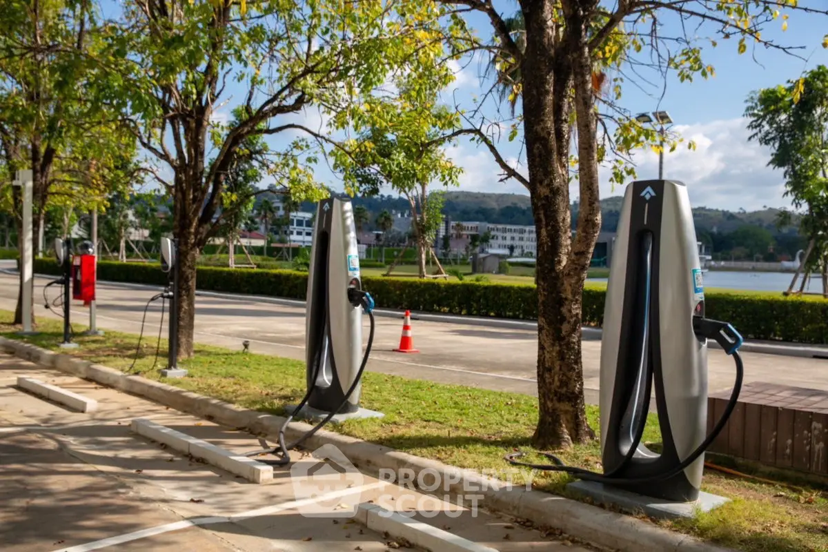 Scenic electric vehicle charging station by the riverside with lush greenery.