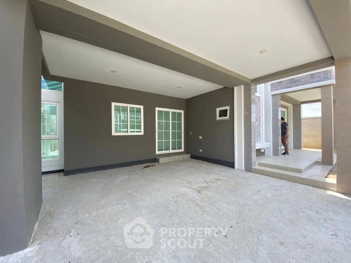 Spacious modern home entrance with large windows and sleek design