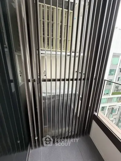 Modern balcony with sleek metal railings and city view, perfect for urban living.