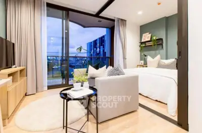 Modern studio apartment with cozy living area and balcony view