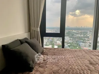 Luxurious bedroom with stunning city view from high-rise window