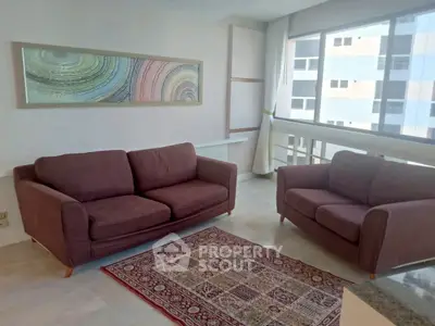 Spacious living room with modern sofas and large window view