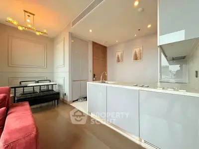 Modern open-layout kitchen and living room with sleek design and elegant lighting