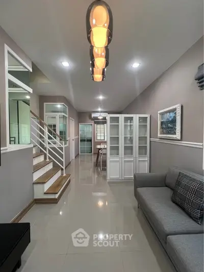 Spacious modern living room with elegant lighting and stylish decor