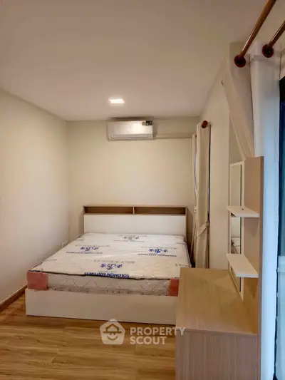 Cozy bedroom with modern furnishings and air conditioning in a stylish apartment.