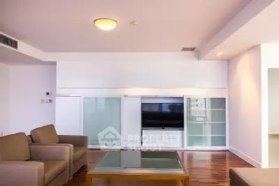 Spacious living room with modern furniture and built-in entertainment center.