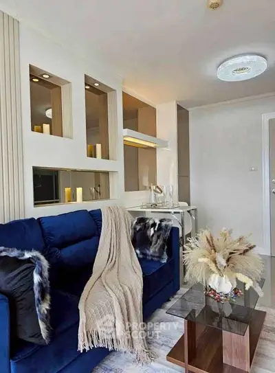 Stylish modern living room with blue sofa and elegant decor