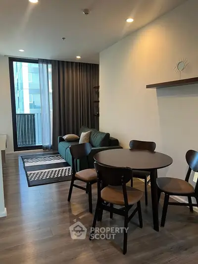Modern living room with stylish furniture and large window in a contemporary apartment.