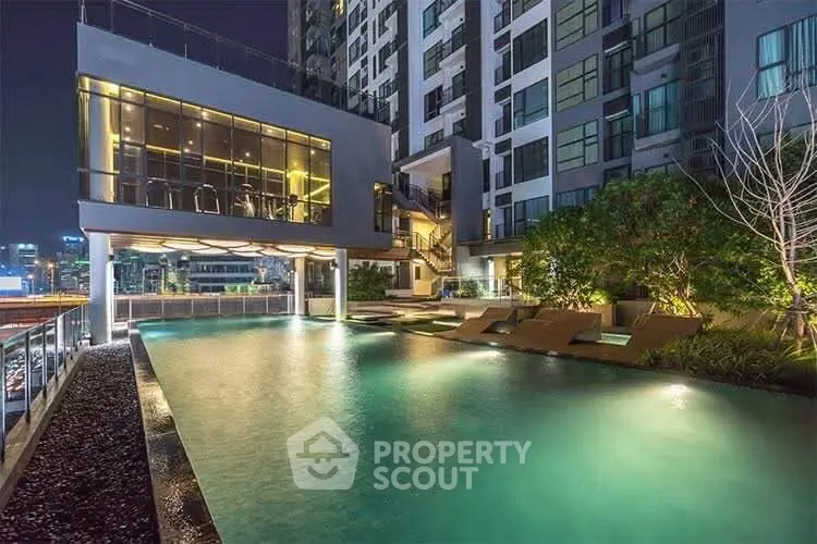 Luxurious high-rise building with illuminated pool and modern design, perfect for urban living.