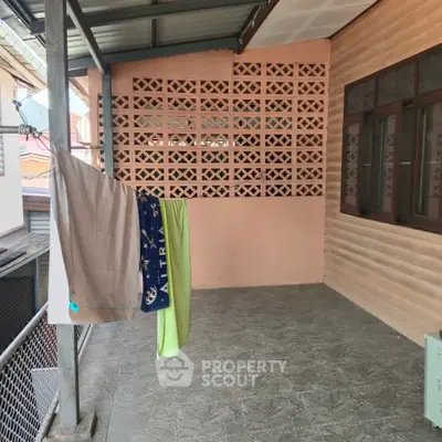 Spacious balcony with privacy wall and tiled flooring, ideal for relaxation or drying clothes.
