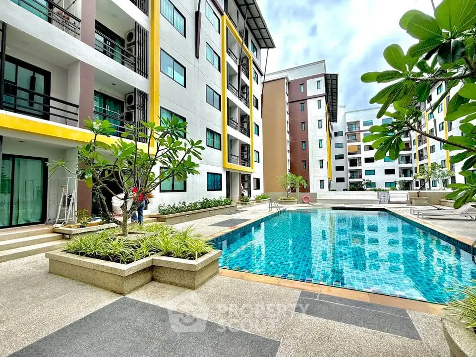 Modern apartment complex with pool and landscaped surroundings, perfect for urban living.