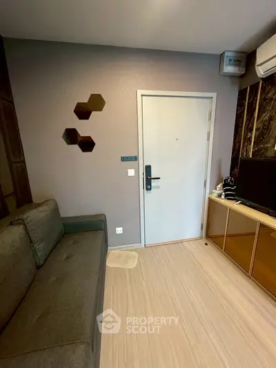 Modern living room with sleek design, featuring a comfortable sofa and stylish wall decor.