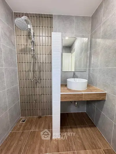 Modern bathroom with stylish shower and elegant vanity in contemporary design.