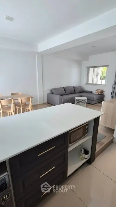Modern open-plan kitchen and living room with sleek design and natural light.
