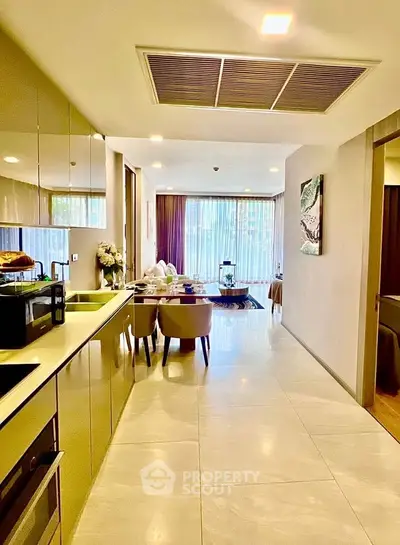 Spacious open-layout kitchen and dining area with modern decor and ample natural light.