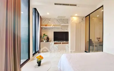 Modern bedroom with large windows and stylish decor in a luxury apartment.