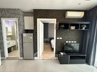 Modern apartment interior with stylish living room and kitchen area, featuring sleek appliances and contemporary decor.