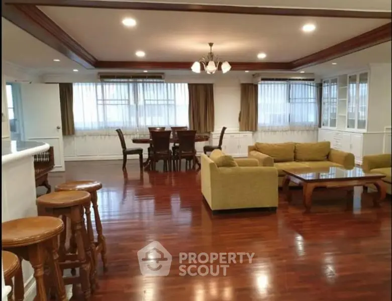 Spacious living room with elegant wooden flooring and stylish furniture